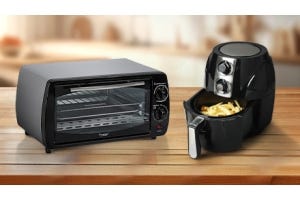 A black convection oven and a black air fryer with fries inside, placed on a wooden countertop