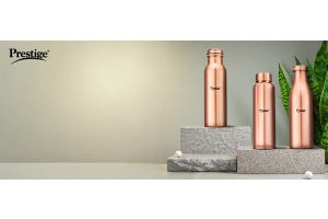 Prestige copper water bottles displayed on stone platforms with a minimalist background